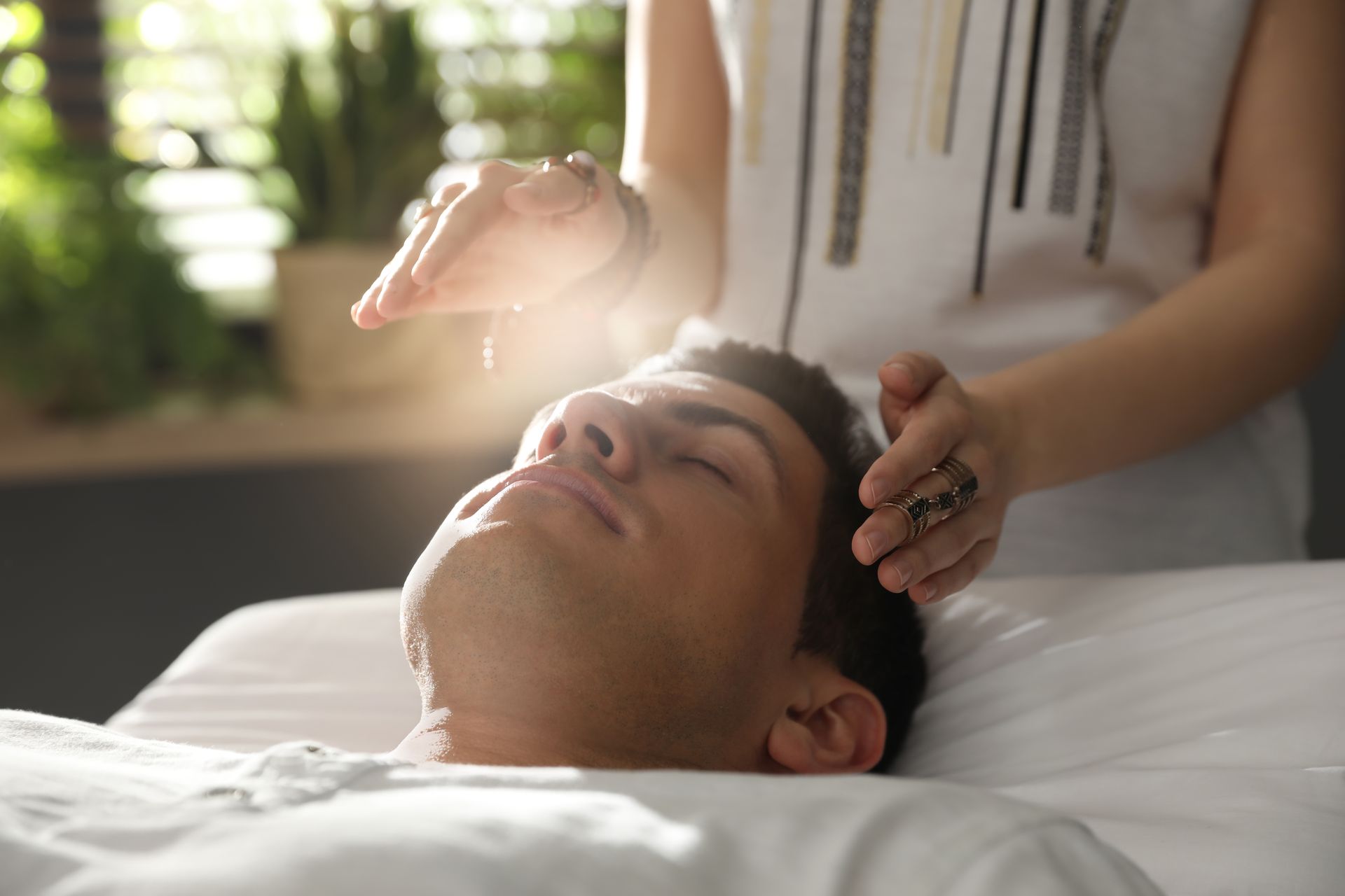 A practitioner working over a reclining client