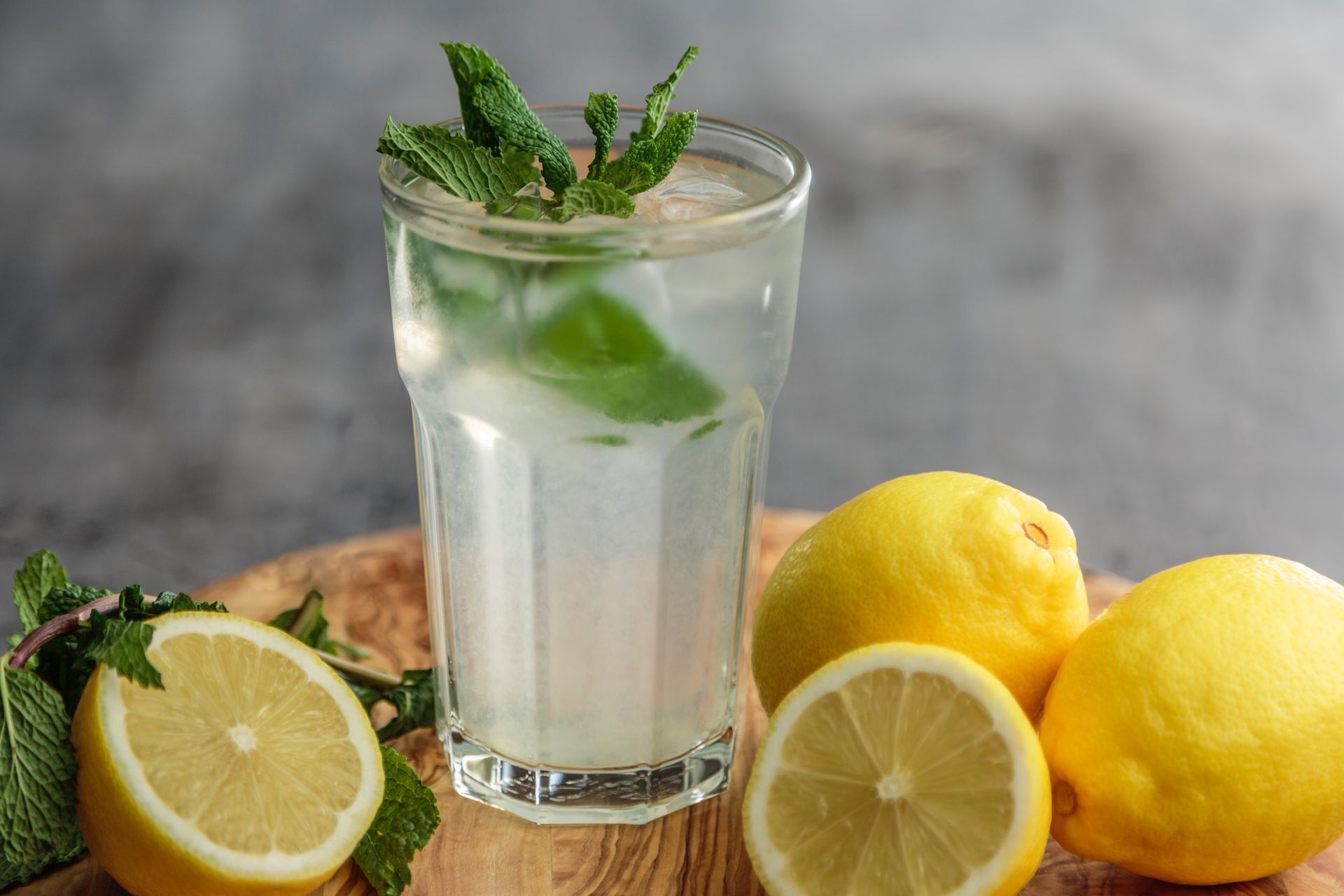 A glass of water with lemon and mint